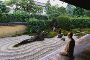 ca. 1990s, Kyoto, Japan --- A Buddhist monk meditate beside a Zen rock garden at the Zuiho-in inside the Daitokuji Temple complex of Kyoto. --- Image by © Catherine Karnow/Corbis